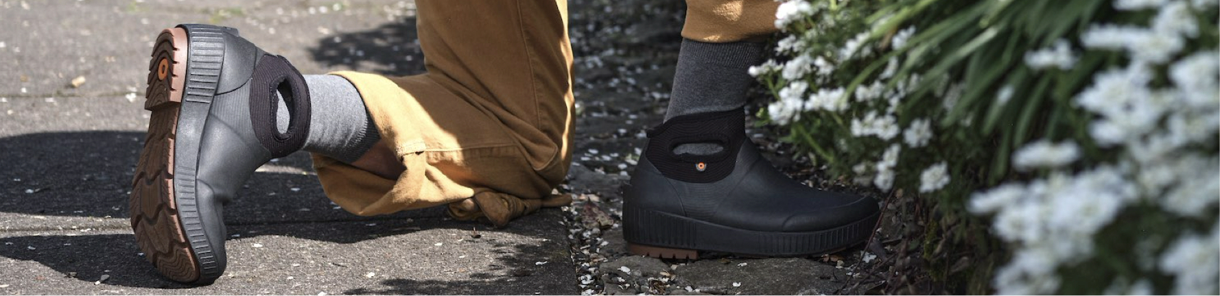 Shop our Women's Seattle II Ankle in black.  The image shown is a closeup of the boot on a sidewalk and white flowers.