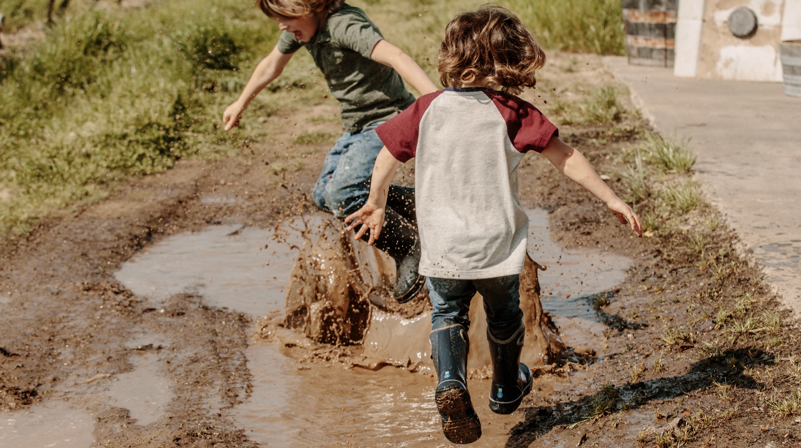 Click to shop kids lightweight styles featuring kids jumping in a mud puddle.