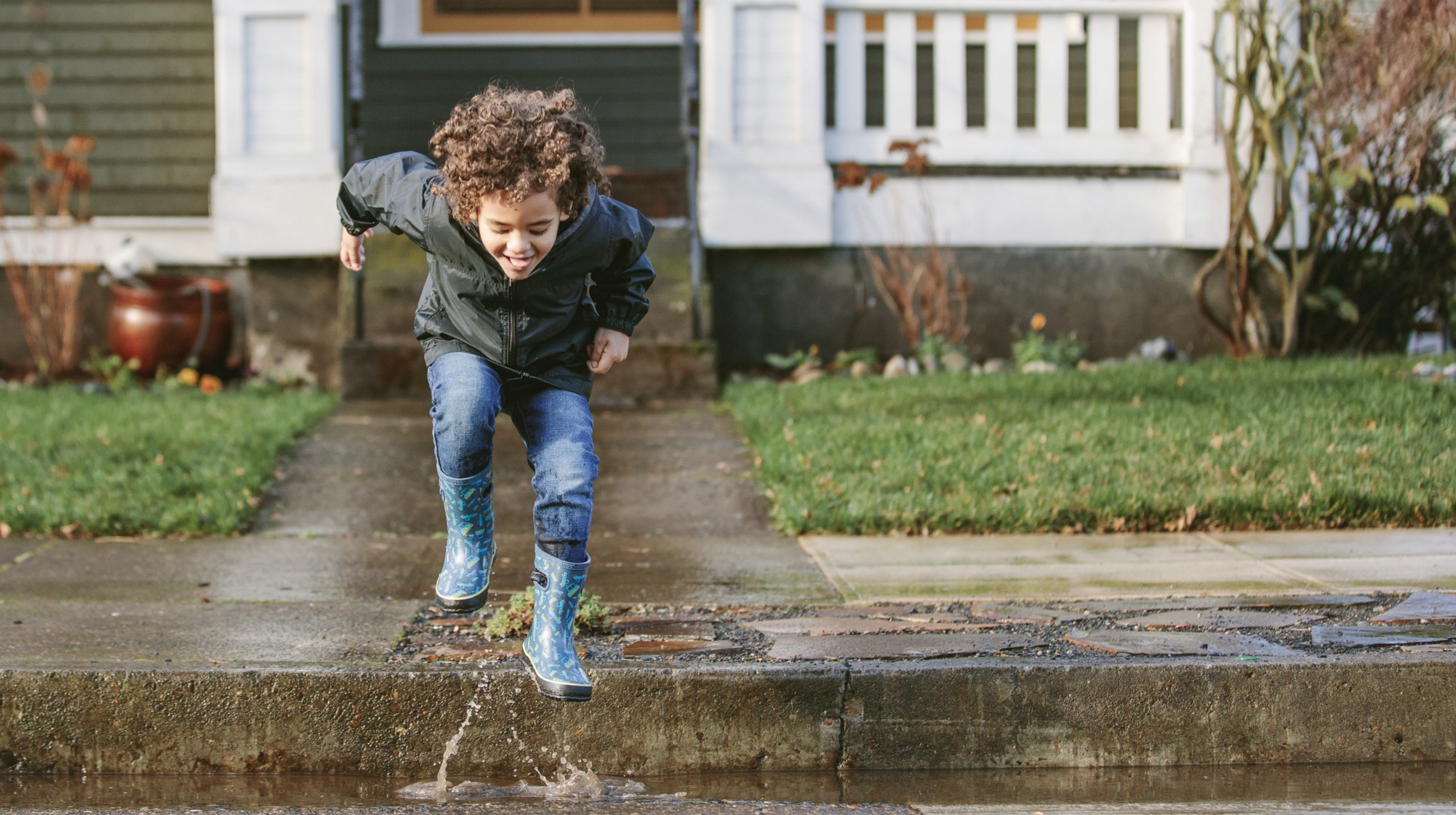 Click to shop our sitewide sale featuring a kid jumping in puddles.
