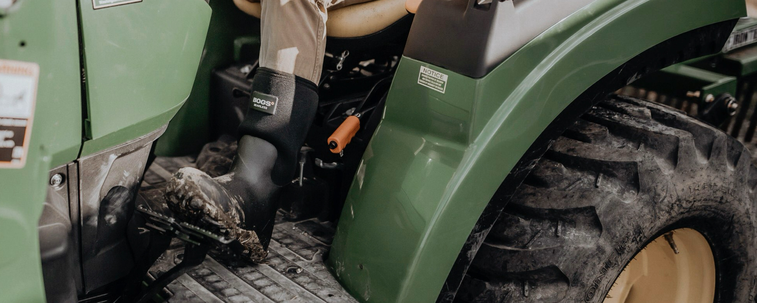 A close up shot of our Men's workman boots on a green tractor
