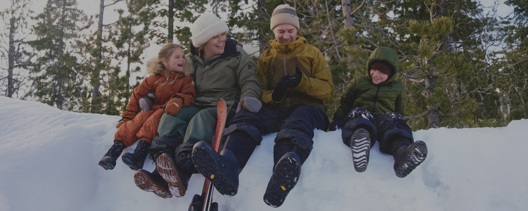Shop our best sellers for the whole family featuring a family sitting on a snow drift.