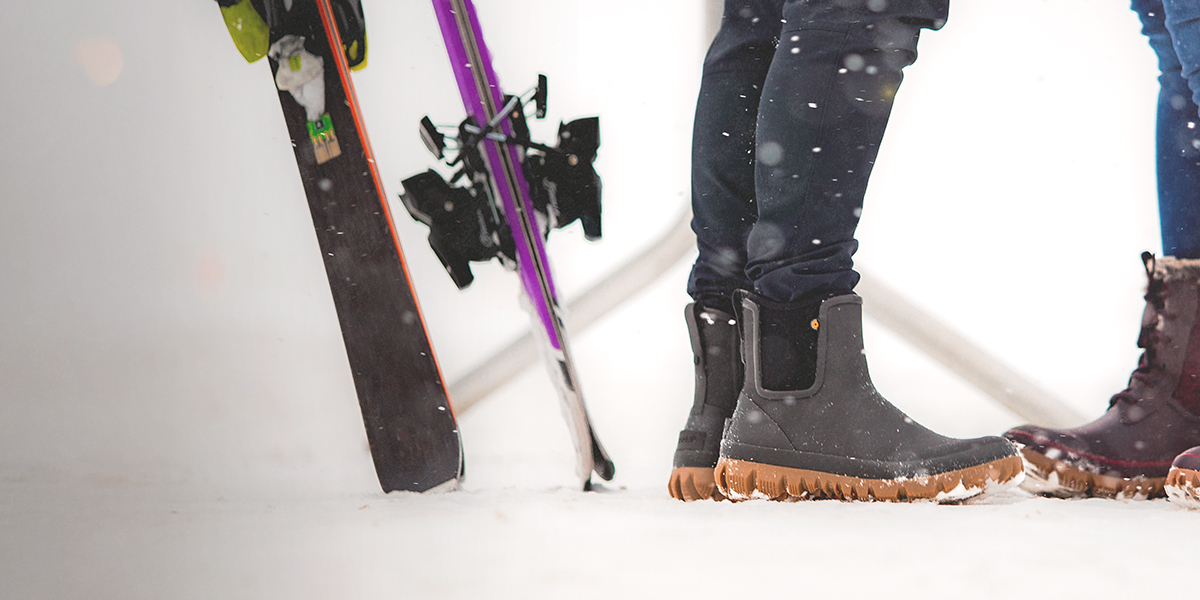 Shop the men's Arcata collection featuring a man standing by his skis.