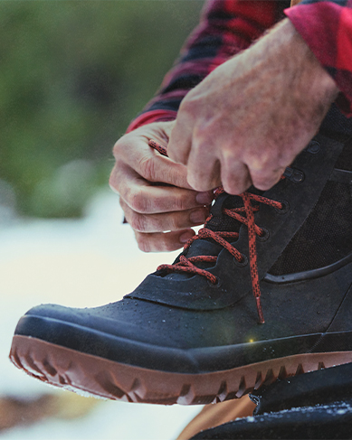 Shop the men's Arcata featuring a man tying the boots.