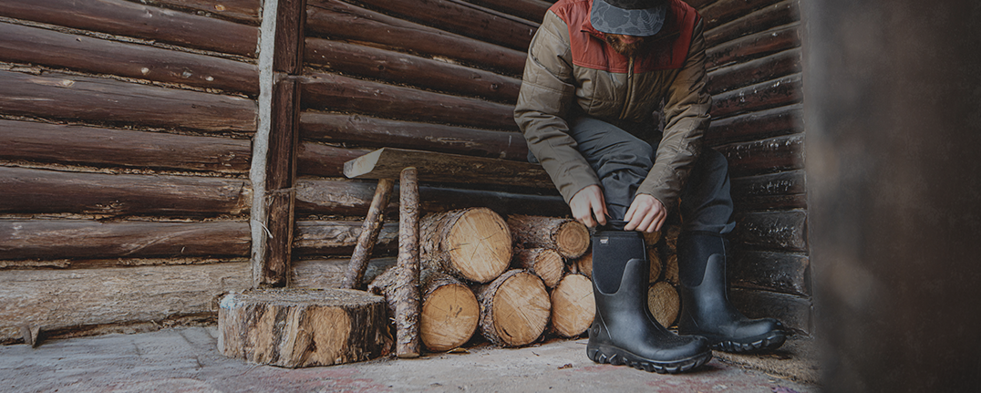 Shop our Seamless Construction featuring a man pulling on boots.