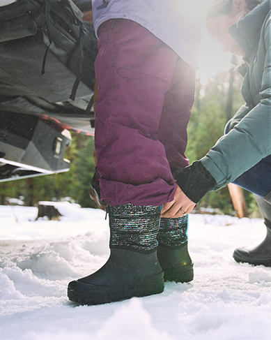 Shop the kids snow shell featuring a kid getting help putting them on.