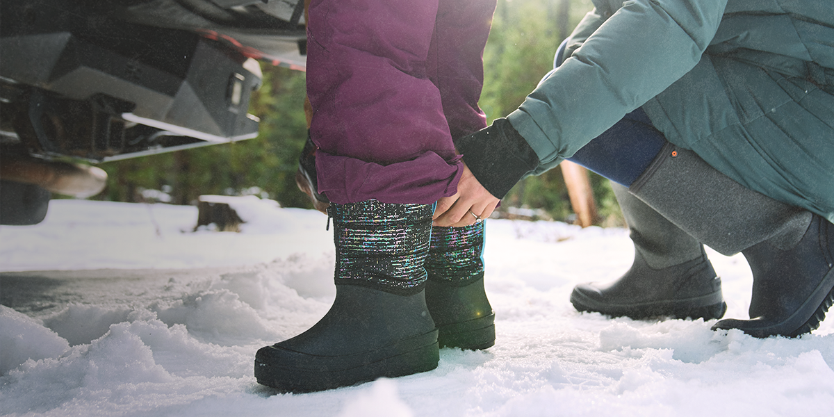 Shop the kids snow shell featuring a kid getting help putting them on.
