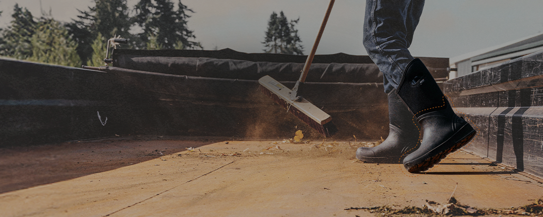 Shop our men's Classic Seamless collection featuring a man sweeping out the bed of a truck.