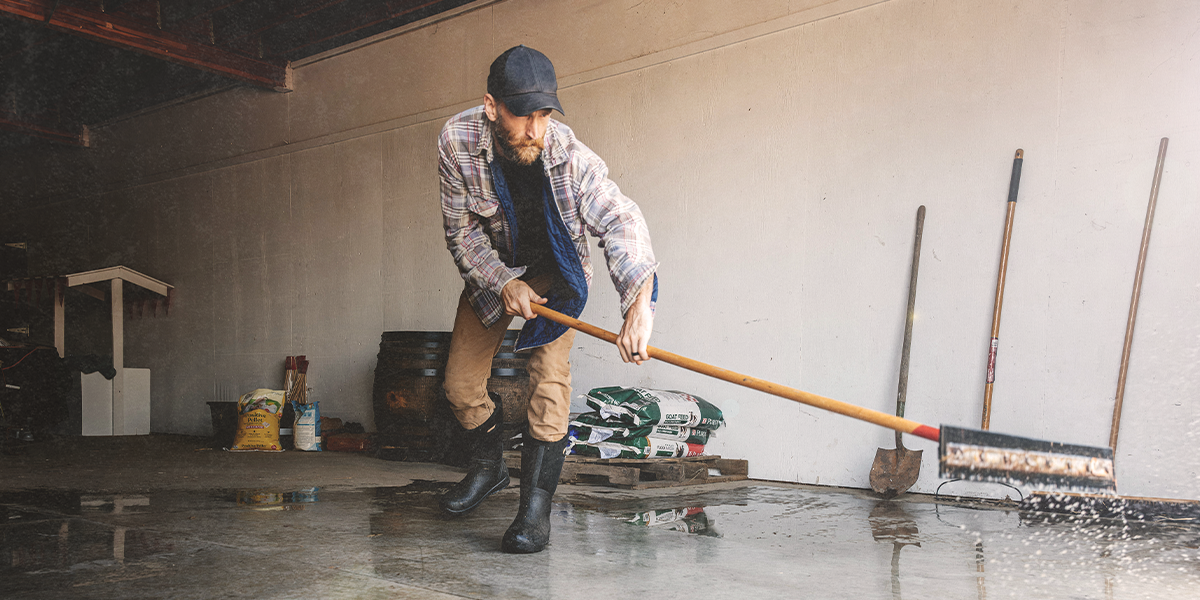 Shop the men's Bozeman II featuring a man cleaning his garage. 