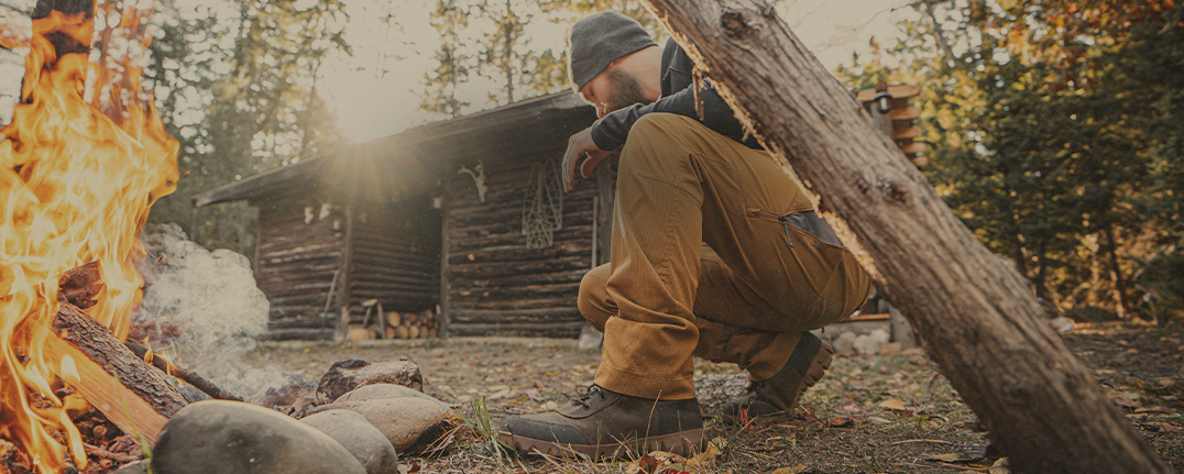 Shop men's fall favorites featuring a man by a campfire.