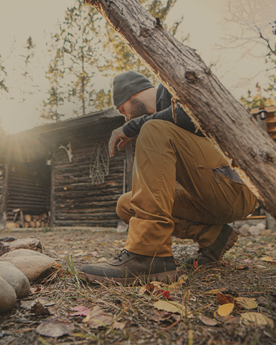 Shop men's fall favorites featuring a man by a campfire.