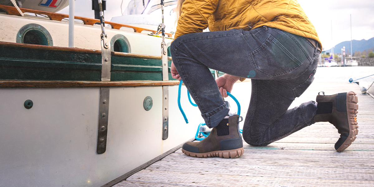 Shop the men's Arcata Urban Leather featuring a man tying up a boat. 