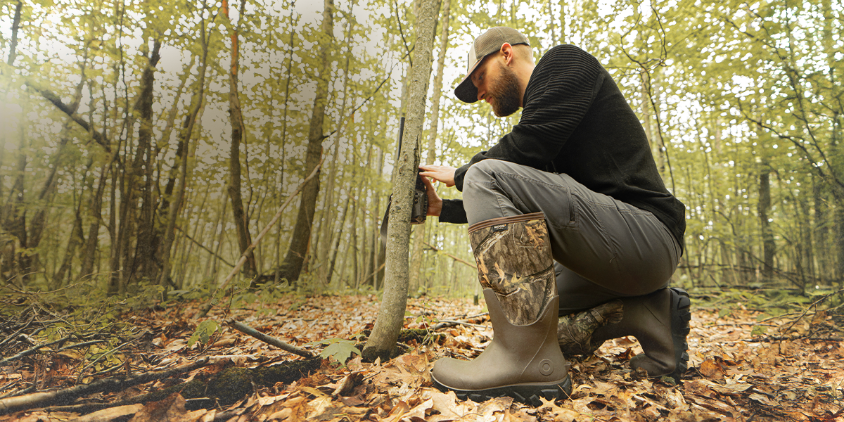 Shop the new men's Classic Seamless boots featuring a man in the woods wearing camo boots. 