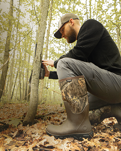 Shop the new men's Classic Seamless boots featuring a man in the woods wearing camo boots. 