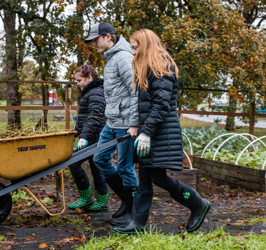 Our Featured Partners. Click here to learn more about kids outdoor education programs that provides experiences where youth learn by doing. The picture shown a three kids pushing a wheel barrel in the garden