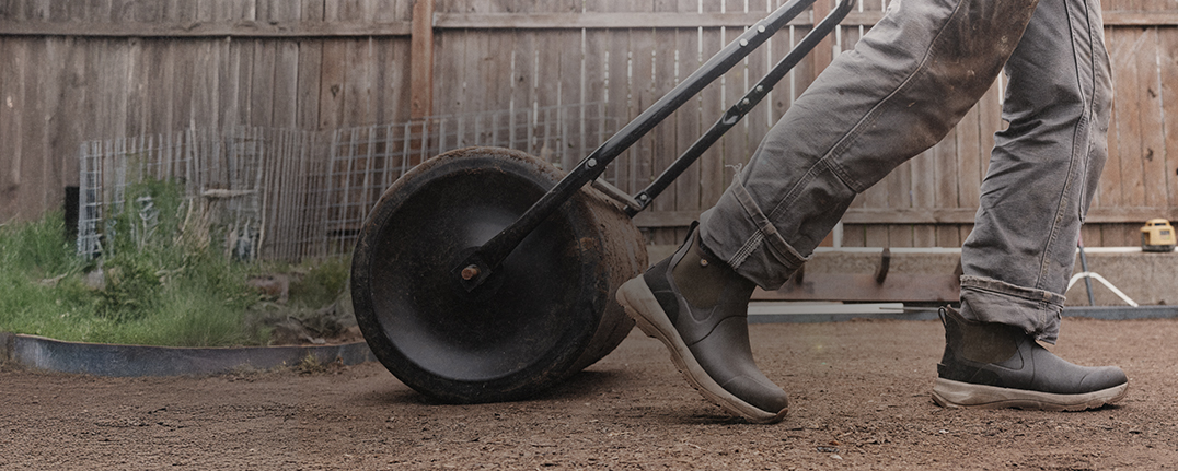 Shop the men's Spruce collection featuring a man walking through the dirt.