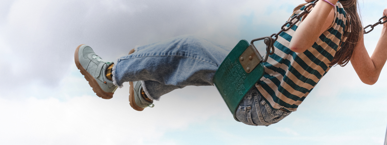 Shop the kids' Skyline Kicker featuring a kid on a swing.