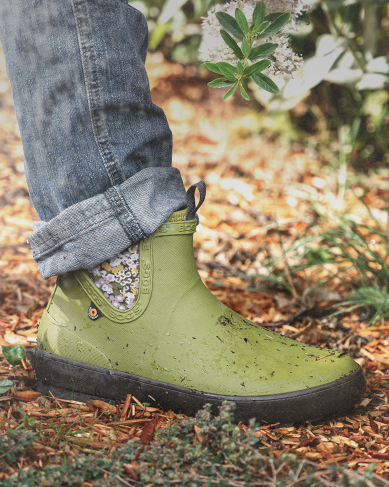 Shop the new Harper featuring the Chelsea Boot in green in a garden.