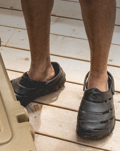 Image features the Boga slip on in black next to a cooler filled with ice.