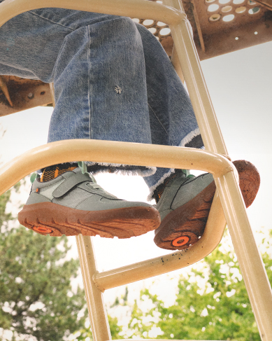 Image features the Skyline Kicker Low in green on a playground.