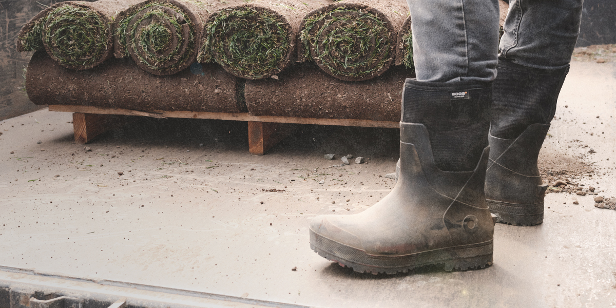 Image features the All Season Mid boot in front of rolls of sod.