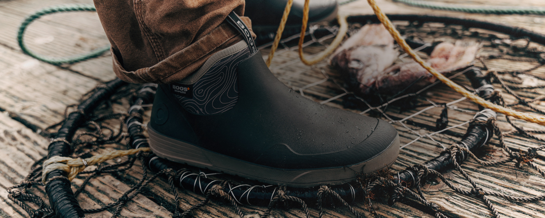 Image features the men's Rockaway low in black on a boat deck with a fishing net.