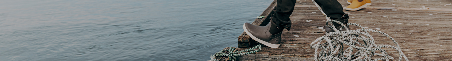 Image features a woman on a dock wearing the Rockaway Chelsea in black
