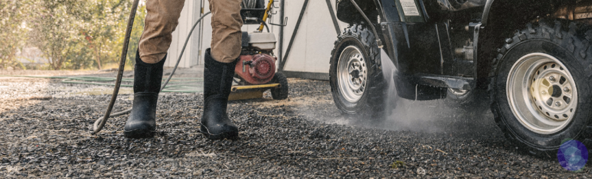 Image features the Bozeman II Tall Boot with a man hosing off his ranger on gravel.