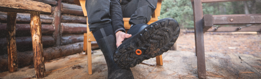 Image features the outsole of the Classic Seamless boot covered in mud.