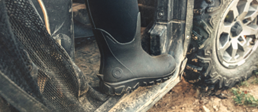 Image shows a BOGS boot sitting inside a muddy vehicle.